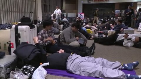 空港内で一夜を明かす人々